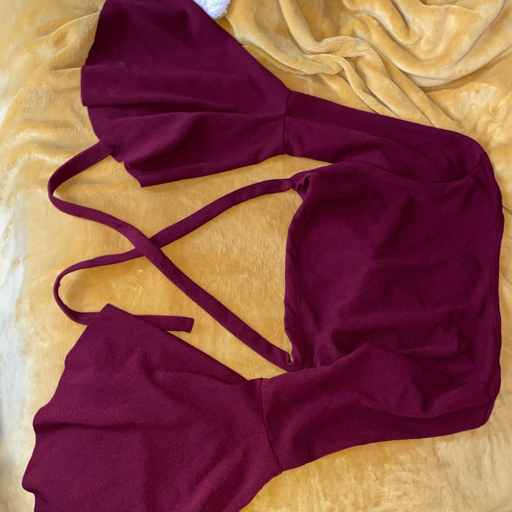 A burgundy crop top that crosses in the back